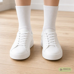 Crew socks worn with white sneakers, ankles only