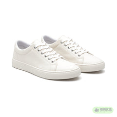 Pair of off-white low-top canvas sneakers with white rubber soles