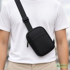 Black crossbody bag worn across the chest, face not shown