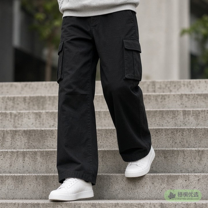 Person wearing black cargo pants and white sneakers on stairs, face not shown